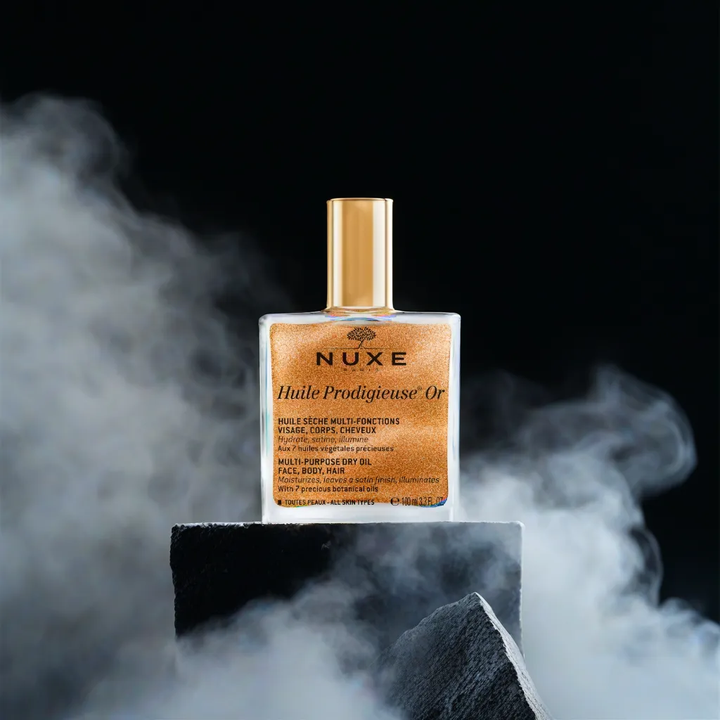 a bottle standing on jagged rock surrounded by smoke, in front of a dark mysterious background