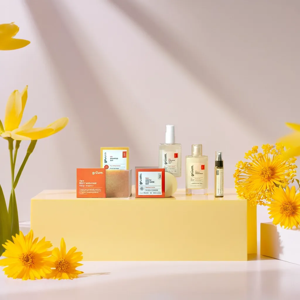 a group of groom products are sitting next to each other on a white background on a translucent yellow platform surrounded by yellow flowers, with sunlight streaming down