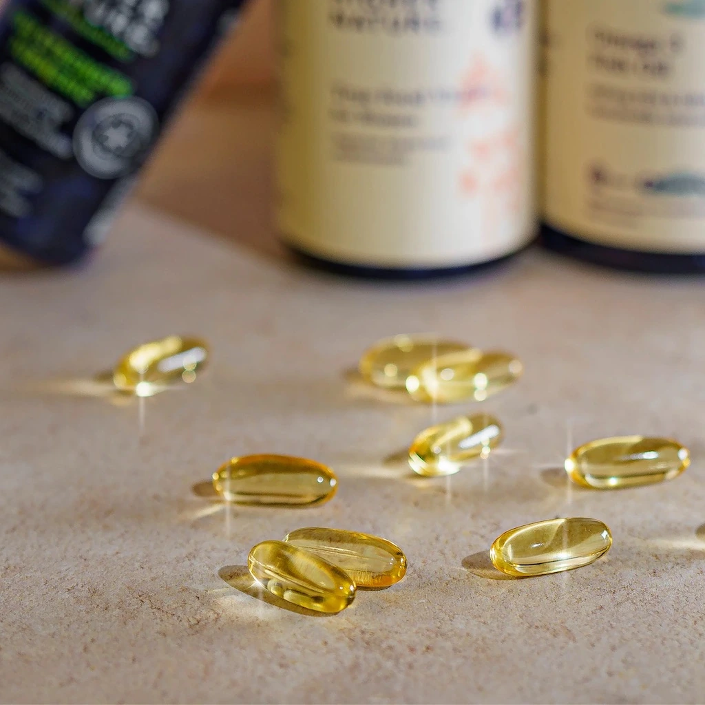 two doses of Omega 3 supplements with some pills on the front